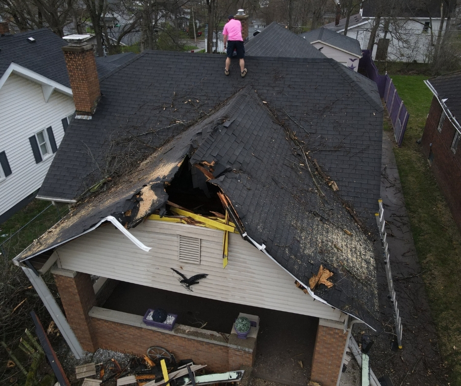 Indy Roof & Restoration documenting and tarps a damaged roof in Indianapolis